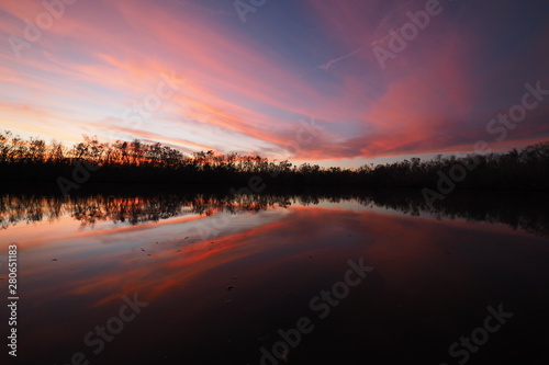 Colorful sunset on Coot Bay Pond in Everglades National Park, Florida on a calm winter evening.