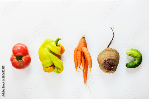Ugly vegetables on a white background. Ugly food concept, flat lay. photo