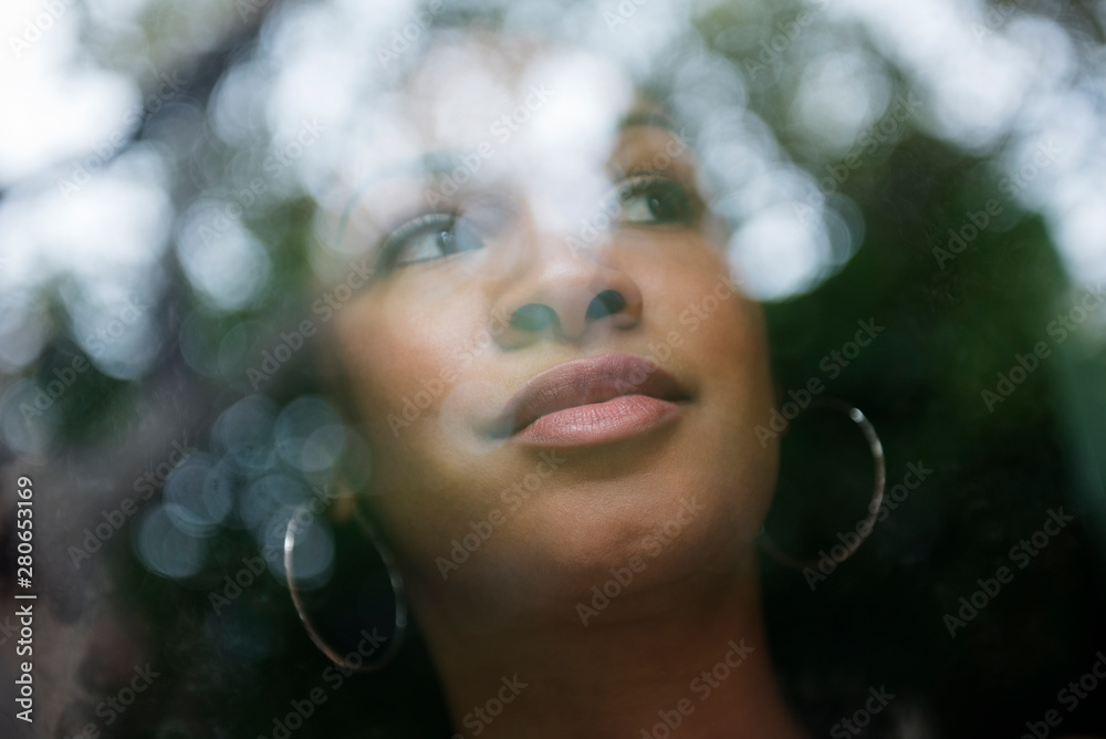 Woman looking out window in morning Woman looking out window in morning