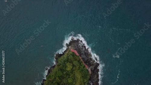 Top view of edge of  green island and breaking waves photo