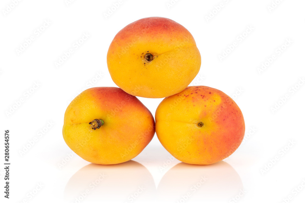 Group of three whole fresh orange apricot arranged to a pyramid isolated on white background Group of three whole fresh orange apricot arranged to a pyramid isolated on white background
