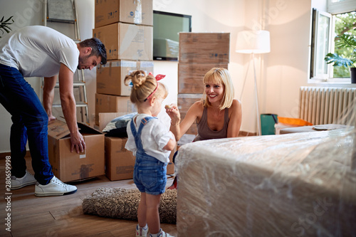 happy family moving into a new house and unpacking