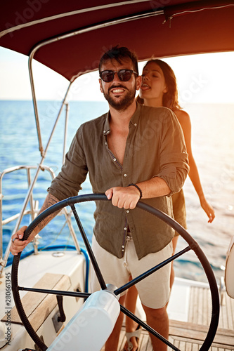 Romantic couple on the luxury boat enjoy at summer day. © luckybusiness