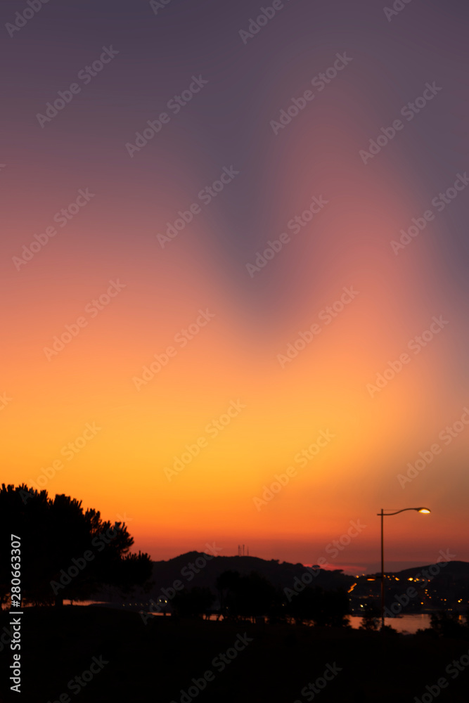 Naklejka premium Sunset on the sea ocean coast with trees. Aurora boreals effect. Wallpaper idea