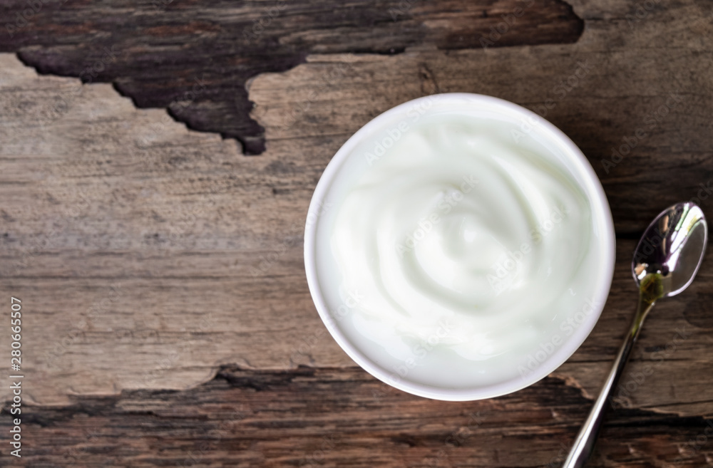 Fresh yogurt In white glass on wood background from top view. Fresh yogurt In white glass on wood background from top view.