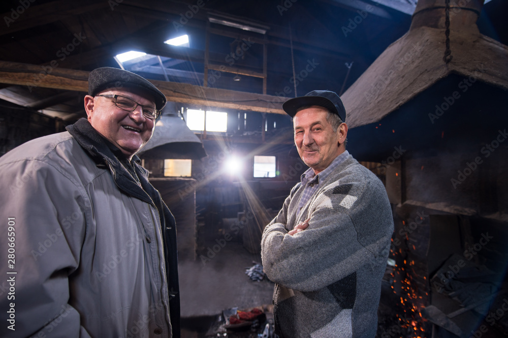 portrait of two confident senior blacksmith