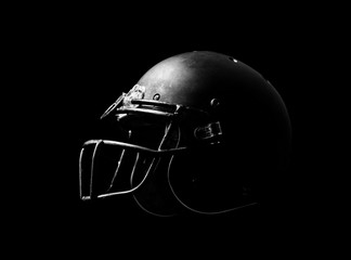 Football helmet on black background.