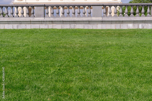 green grass with marble fence on the background. nature, architecture
