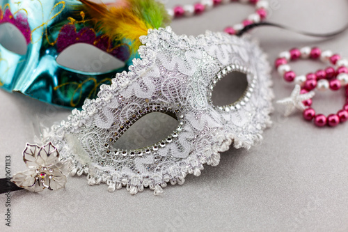A festive,Beautiful white mardi gras or carnival mask on beautiful colorful paper background