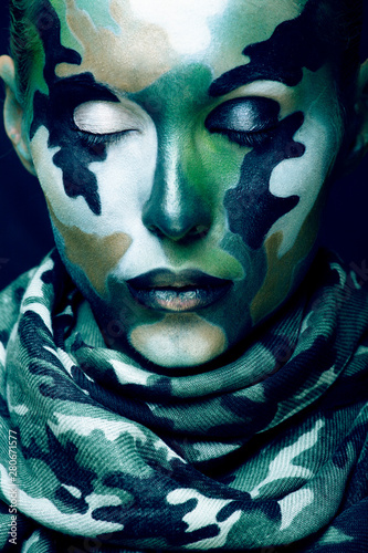 Beautiful young fashion woman with military style clothing and face paint make-up  khaki colors  halloween celebration