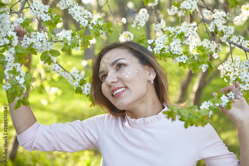 girl with flowers. gorgeous model in the spring garden. the girl near the tree in the spring. girl with flowers. gorgeous model in the spring garden. the girl near the tree in the spring.