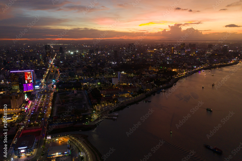 Top View of Building in a City - Aerial view Skyscrapers flying by drone of Phnom Penh city with riverside , Palace and small island in sunset