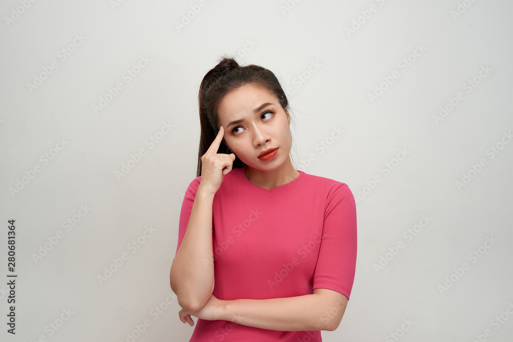 Portrait of thinking woman holding fingers on temples looking up having frustrated look trying to remember something important. Portrait of thinking woman holding fingers on temples looking up having frustrated look trying to remember something important.