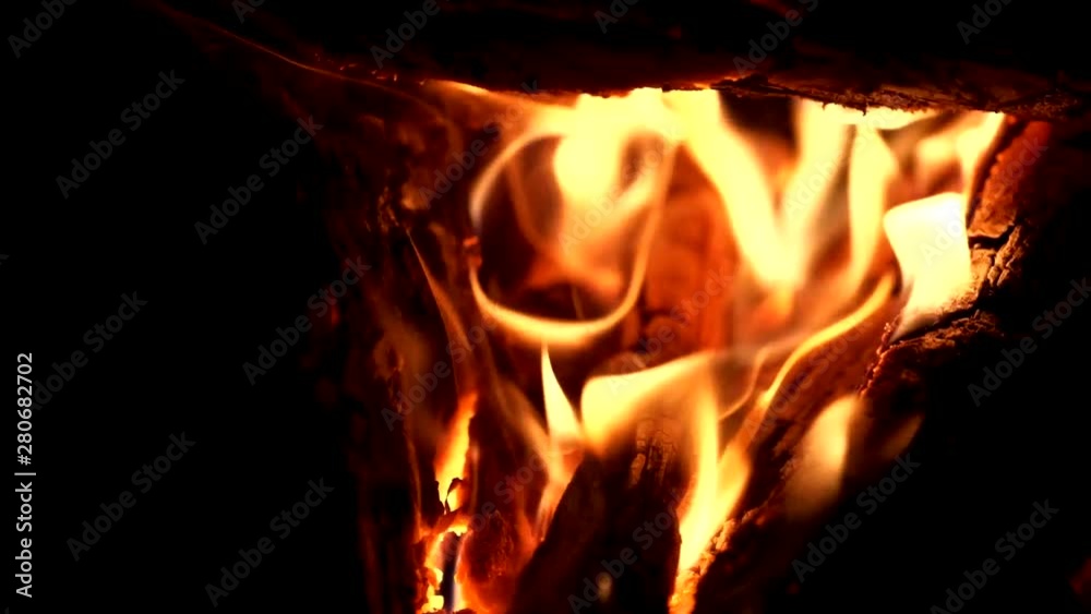 bright red yellow flames of fire in the dark. black background bright red yellow flames of fire in the dark. black background