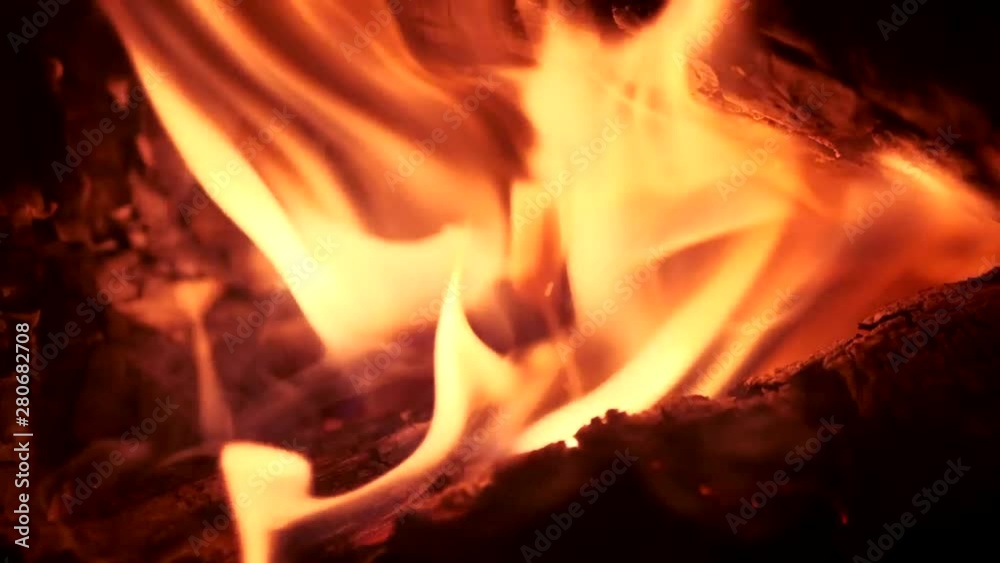 bright red yellow flames of fire in the dark. black background bright red yellow flames of fire in the dark. black background