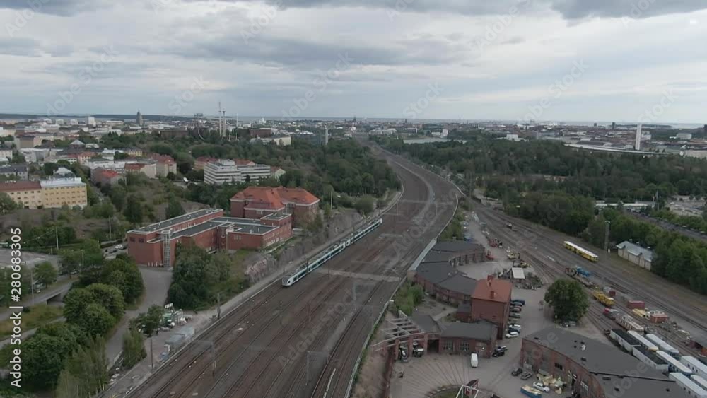 Slow motion. Flying over the train and railways in city of Helsinki. Aerial drone shot. Finland. Slow motion. Flying over the train and railways in city of Helsinki. Aerial drone shot. Finland.