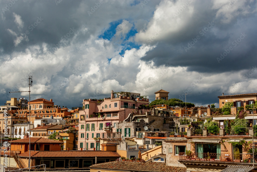 Roman urban landscape of houses with rooftop gardens on a cloudy blue sky background