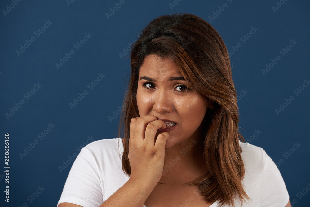 Portrait of woman eating nails