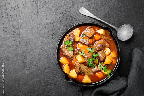 Beef meat  stewed with potatoes, carrots and spices (hungarian goulash). photo