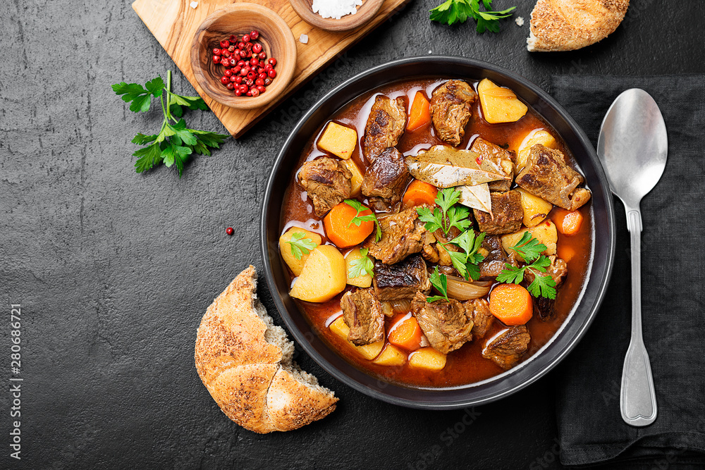 Beef meat stewed with potatoes, carrots and spices (hungarian goulash). Beef meat stewed with potatoes, carrots and spices (hungarian goulash).