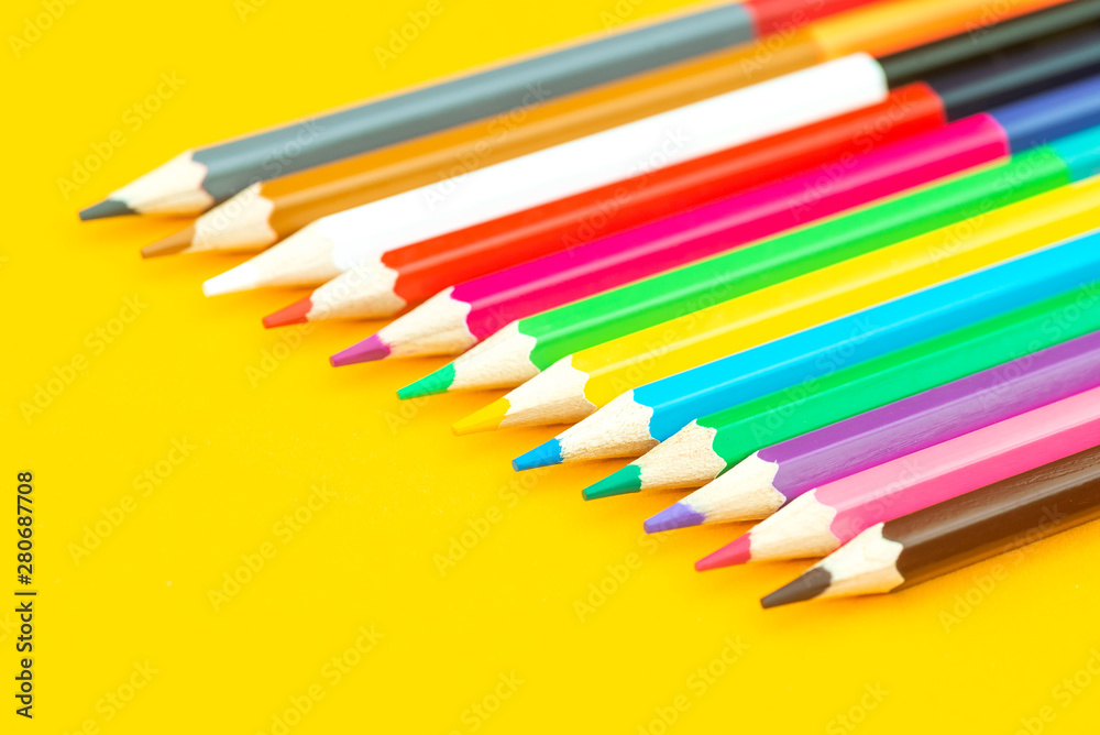 Multicolored pencil on yellow background Multicolored pencil on yellow background