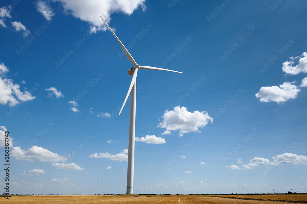 wind generator on bright cloudy sky background