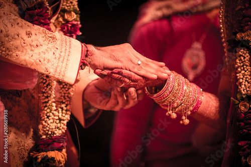 Closeup of indian hindu couple holding each other hands during marriage symbolizing love togetherness and promise