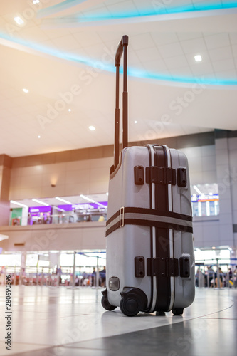 Vertical luggage strapped with straps to protect bag from opening during travel or ready to move placed at airport departure lounge. Travel Insurance or transport concept
