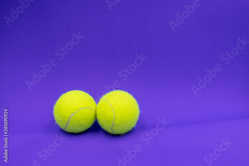 Tennis ball on purple background © thaninee