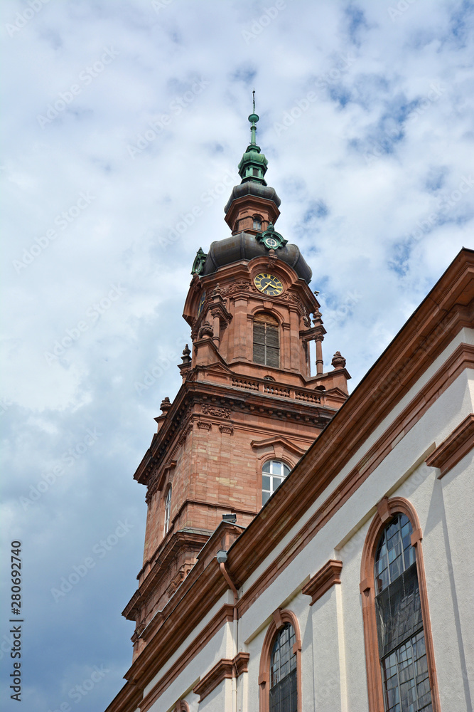 Clock tower of German city chucrh called 'CityKirche Konkordien' in city of Mannheim in front of cloudy summer sky