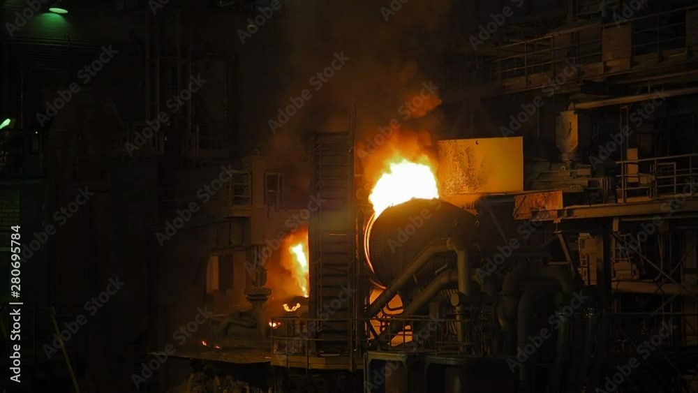 Molten metal pouring. Casting liquid metal. Molten metal melted in furnace at metallurgical plant. Iron and Steel Works. Converter plant. Smelting of metal. Molten metal pouring. Casting liquid metal. Molten metal melted in furnace at metallurgical plant. Iron and Steel Works. Converter plant. Smelting of metal.