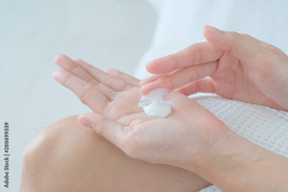 Woman applying moisturizing cream/lotion on hands, beauty concept. Woman applying moisturizing cream/lotion on hands, beauty concept.