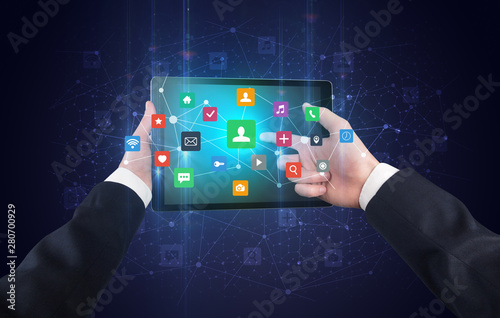 Hand using tablet with colorful bounce application symbols and icons concept