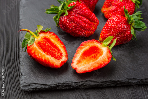 Fresh strawberries on dark background.