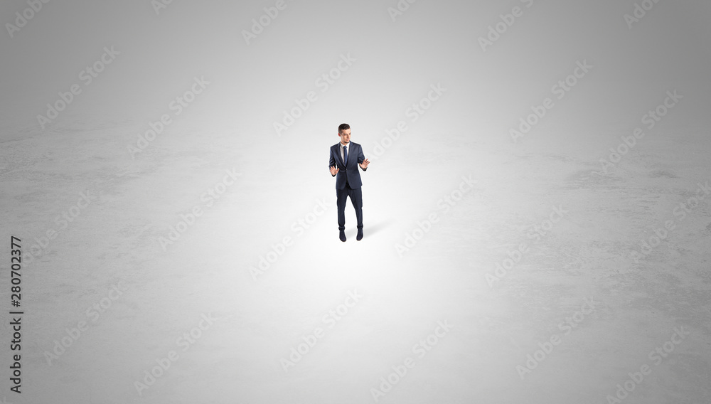 Young businessman standing alone in the middle of an empty space