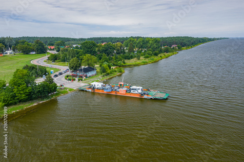Aerial view of ferry at the Vistula river mouth to the Baltic sea. Poland. Photo made by drone from above. Bird eye view.