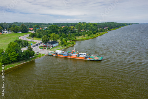 Aerial view of ferry at the Vistula river mouth to the Baltic sea. Poland. Photo made by drone from above. Bird eye view. photo
