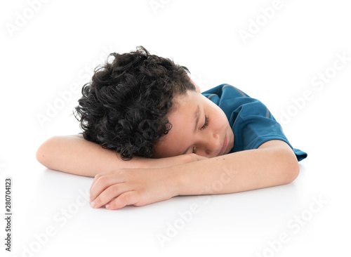 Little Young Exausted Lazy Boy Fell Asleep on White Table, Studio Shot, Isolated on White Background photo