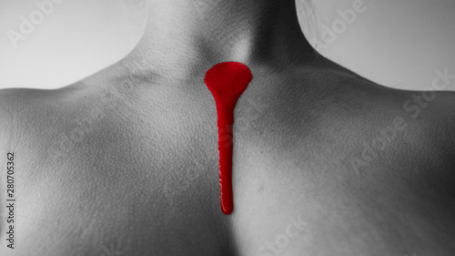 Red painting on woman chest, fine art photography
