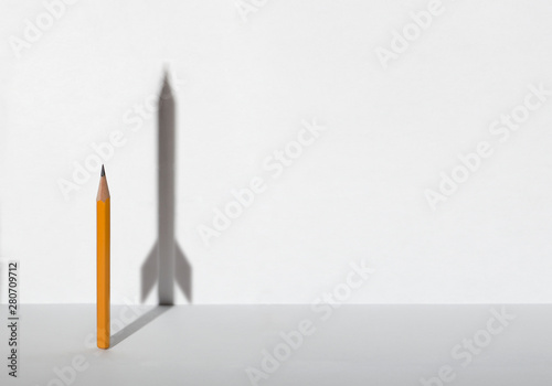 Pencils and a shadow in form of spacecraft . Success, cureer and solving problems business concept. Copy space for text .