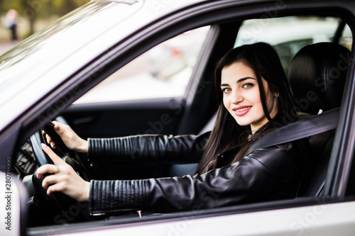 Beautiful young happy smiling woman driving her new car © dianagrytsku