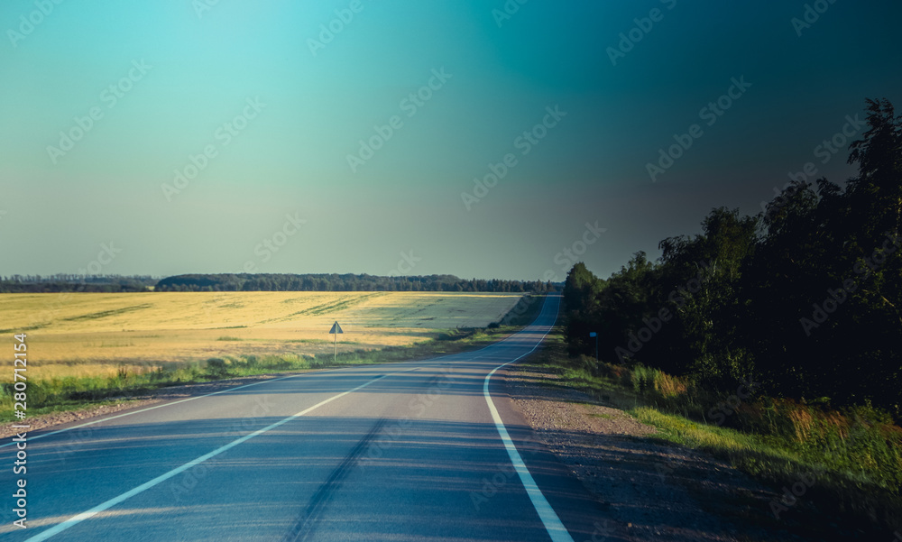 Russian asphalt roads. Highway. Road trip. The car goes on the road. Background asphalt road.