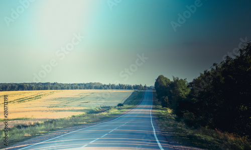 Russian asphalt roads. Highway. Road trip. The car goes on the road. Background asphalt road.