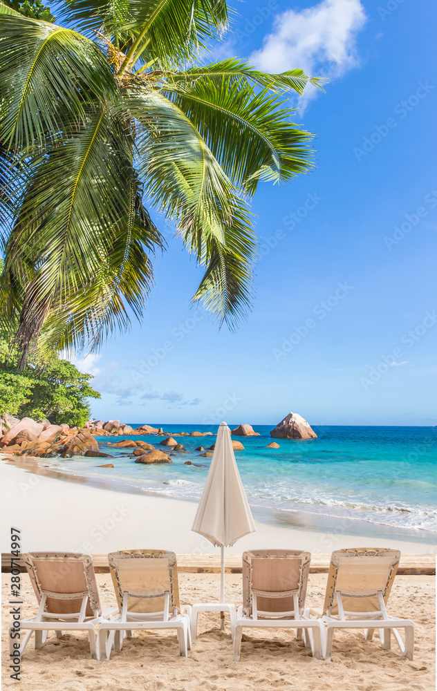 tropical beach with palm trees and chairs, Seychelles 