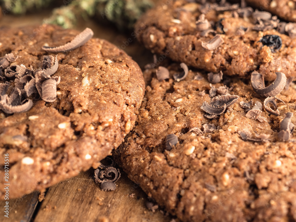 Fototapeta premium textured chocolate hemp oatmeal cookies on a wooden board