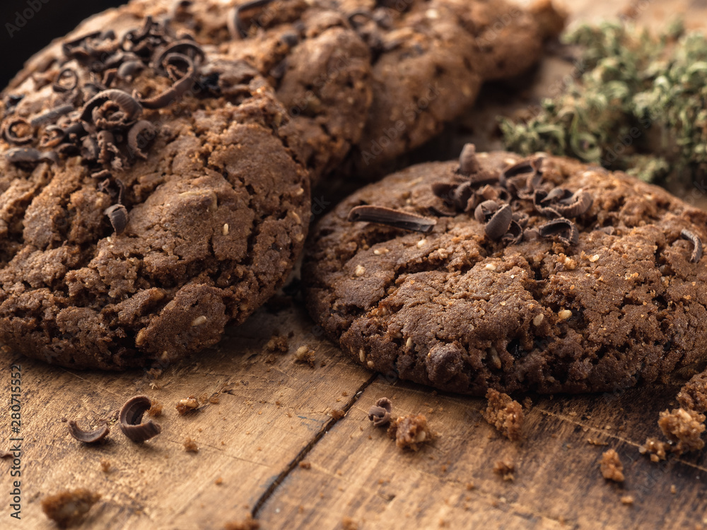 textured chocolate hemp oatmeal cookies on a wooden board textured chocolate hemp oatmeal cookies on a wooden board