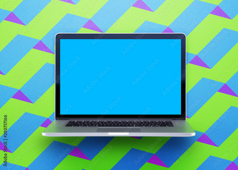 Computer staying on a table & showing the screen. Trendy & vibrant design. Geometry. Innovational digital internet applications & web business solutions. Modern workspace in an office. Development.