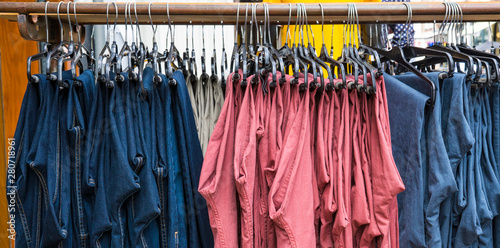 blue, pink, red, pants hanging on rack