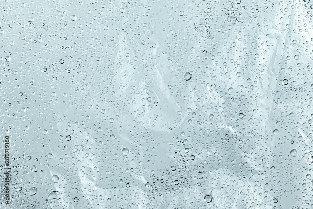 Plastic bag and wet surface with water droplets background. Abstract of dew wallpaper.