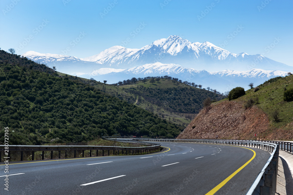 Empty clean road inside nature with snowy high mountains. Bozdag izmir Turkey